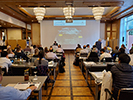 View of the audience and speaker from the back of the room