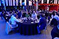 workshop attendees eating and listening to speakers at the banquet