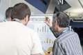 workshop attendees walking around and looking at the posters