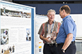 workshop attendees walking around and looking at the posters