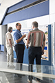 workshop attendees walking around and looking at the posters