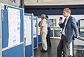 workshop attendees walking around and looking at the posters