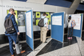 workshop attendees walking around and looking at the posters