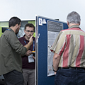 workshop attendees walking around and looking at the posters