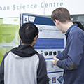 workshop attendees walking around and looking at the posters