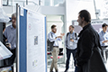 workshop attendees walking around and looking at the posters